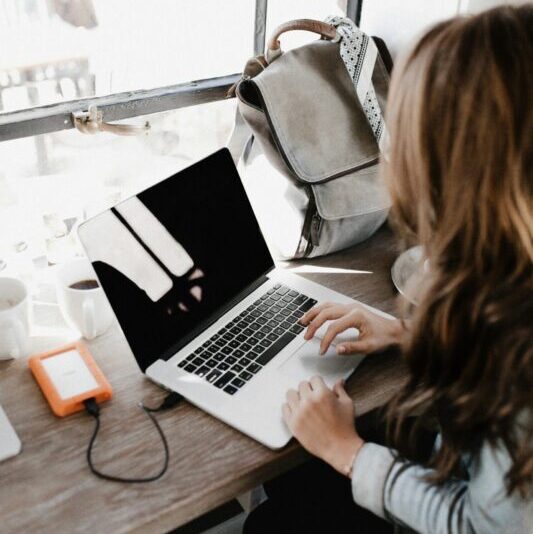 Student sitting at desk working on a laptop